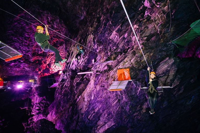 ziplining in cave at zipworld