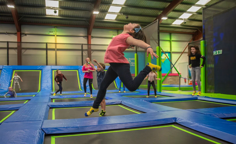 young girl jumping on trampoline